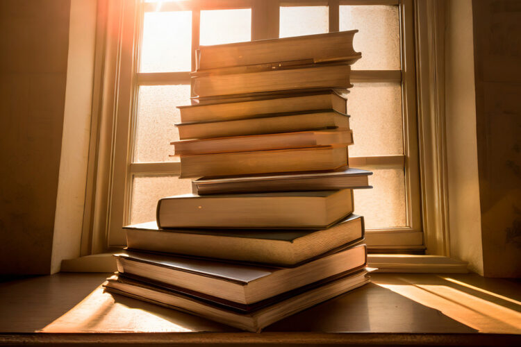 Firefly-photographs-of-a-big-stack-of-books-by-a-window-26387